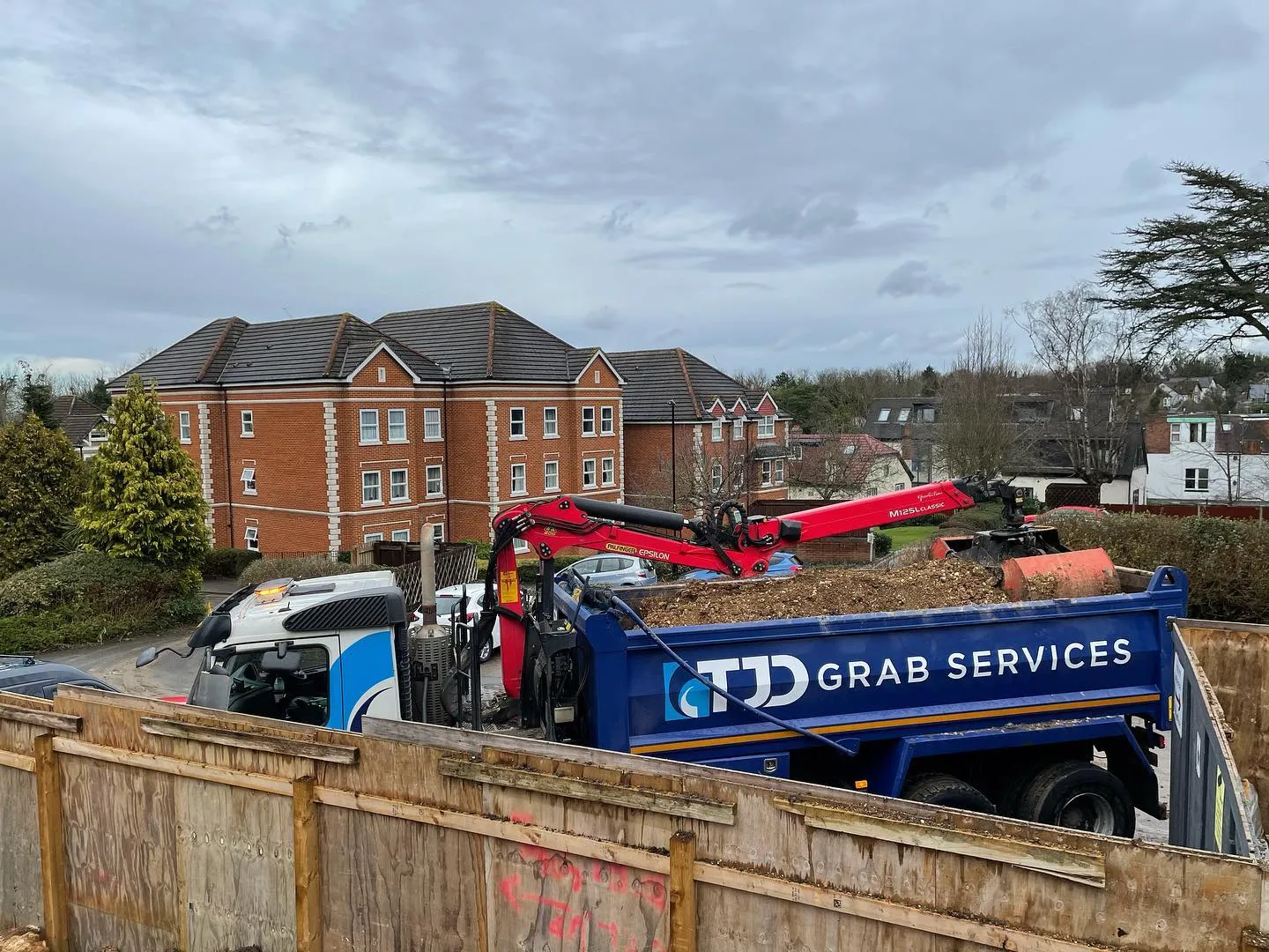 A dump truck with a load of dirt in the back.